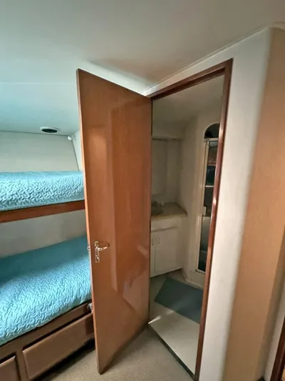  Yacht Photos Pics 1998 Viking 58 Convertible yacht interior with bunk beds and bathroom.