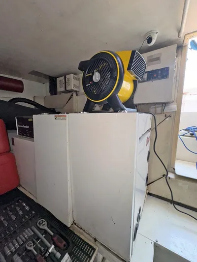  Yacht Photos Pics Engine room of a 1998 Viking 58 Convertible yacht with tools and equipment.