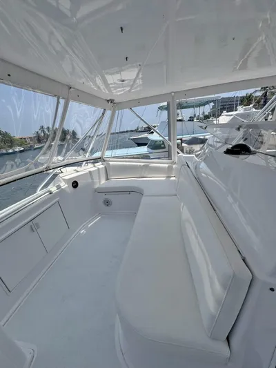  Yacht Photos Pics 1998 Viking 58 Convertible boat interior with white seating and windows.