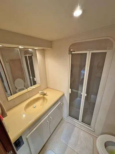  Yacht Photos Pics Bathroom interior of a 1998 Viking 58 Convertible yacht with shower and vanity.