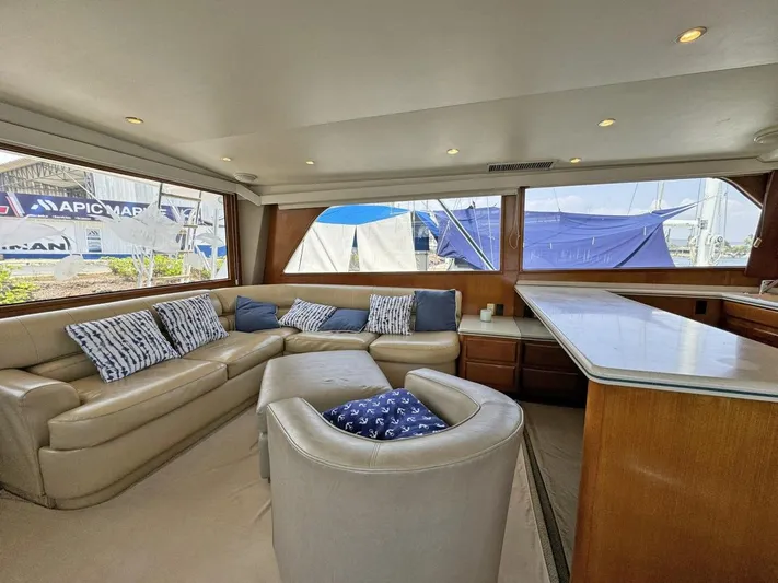  Yacht Photos Pics Interior of 1998 Viking 58 Convertible yacht with beige leather seating and large windows.