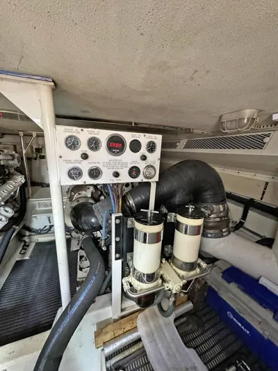  Yacht Photos Pics Engine room of a 1998 Viking 58 Convertible yacht with control panel and filters.