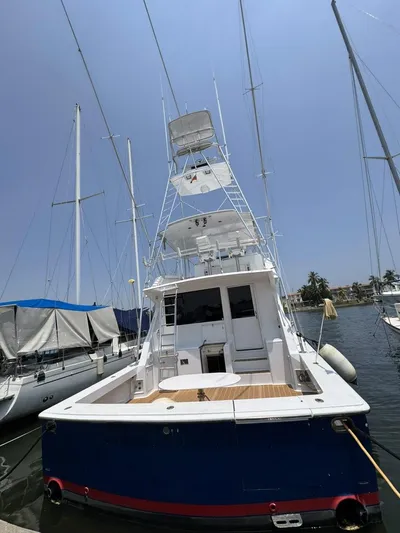  Yacht Photos Pics 1998 Viking 58 Convertible yacht docked at marina on a sunny day.