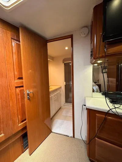  Yacht Photos Pics Interior of 1998 Viking 58 Convertible yacht with wooden cabinetry and open bathroom door.