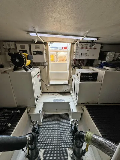  Yacht Photos Pics Engine room of a 1998 Viking 58 Convertible yacht with equipment and control panels.