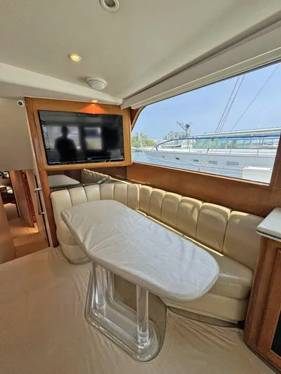  Yacht Photos Pics 1998 Viking 58 Convertible yacht interior with dining area and TV.