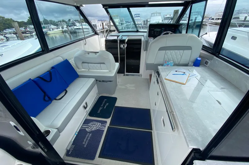 Camelot Yacht Photos Pics Interior of 2022 Regal 36 XO yacht with seating, helm, and countertop.