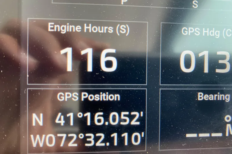 Camelot Yacht Photos Pics Display screen showing 116 engine hours and GPS coordinates on a 2022 Regal 36 XO.