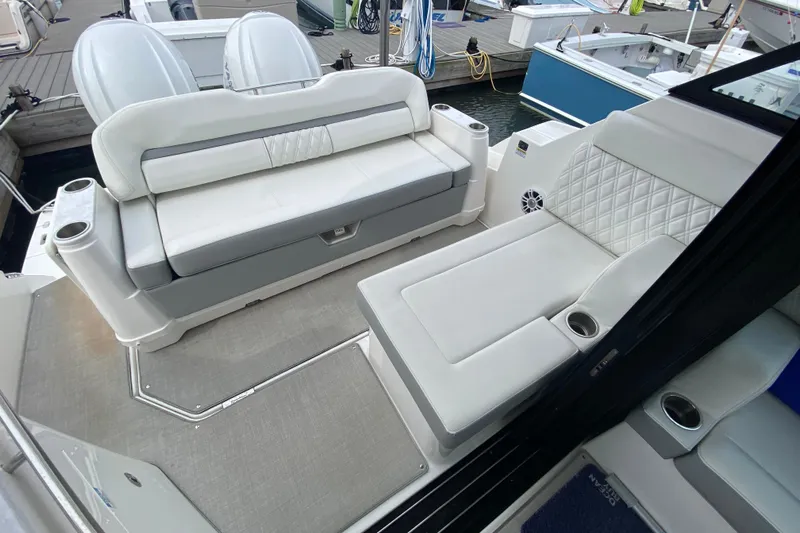 Camelot Yacht Photos Pics 2022 Regal 36 XO boat interior with luxurious white seating and cup holders.