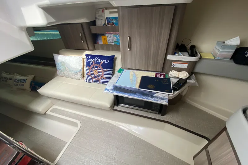 Camelot Yacht Photos Pics Interior of 2022 Regal 36 XO yacht with cozy seating and nautical decor.