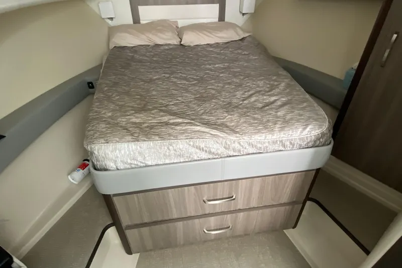 Camelot Yacht Photos Pics Interior cabin of 2022 Regal 36 XO yacht with bed and storage drawers.