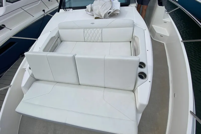 Camelot Yacht Photos Pics 2022 Regal 36 XO boat with white cushioned seating and cup holders.