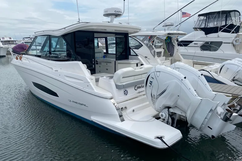 Camelot Yacht Photos Pics 2022 Regal 36 XO boat docked, featuring twin outboard engines and sleek design.