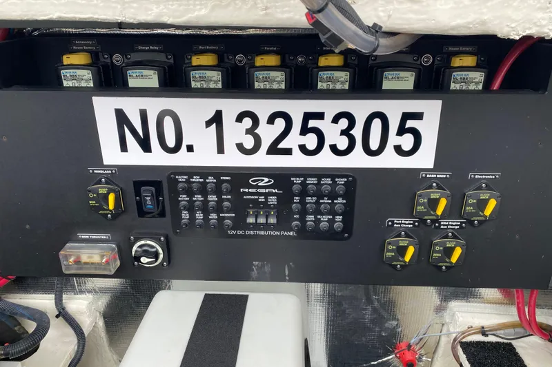 Camelot Yacht Photos Pics Control panel of a 2022 Regal 36 XO boat with various switches and circuit breakers.