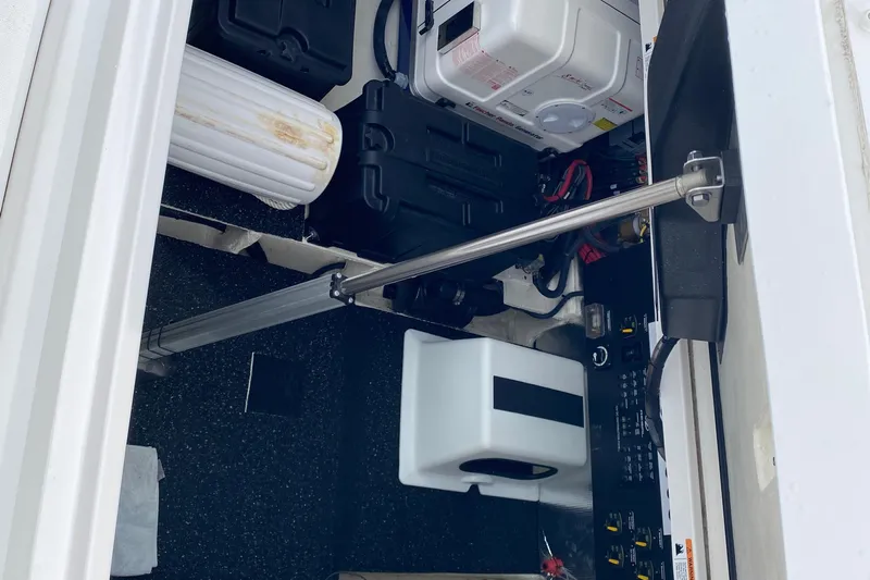 Camelot Yacht Photos Pics Engine compartment of 2022 Regal 36 XO boat, showcasing mechanical components and storage.