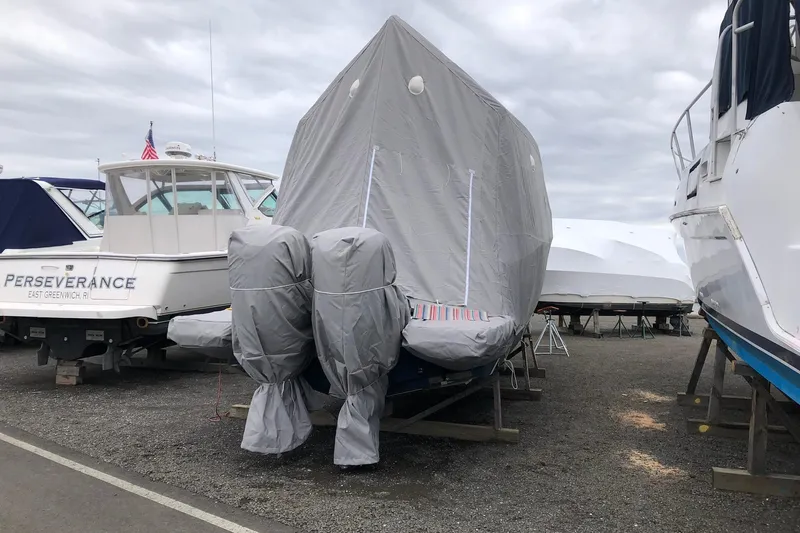 Camelot Yacht Photos Pics Covered 2022 Regal 36 XO boat in storage, surrounded by other boats.