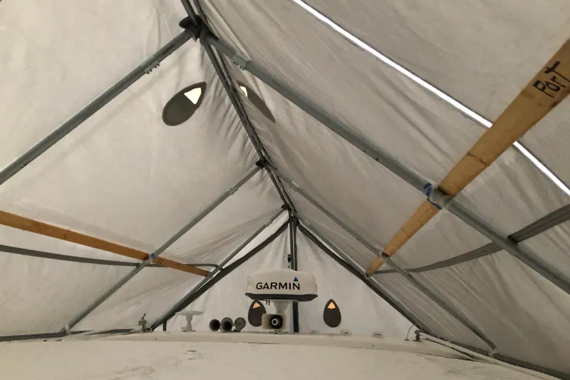 Camelot Yacht Photos Pics Covered 2022 Regal 36 XO boat with Garmin equipment under protective shelter.