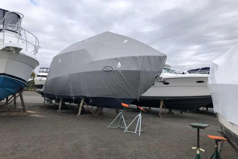 Camelot Yacht Photos Pics Covered 2022 Regal 36 XO boat in storage yard with other vessels.