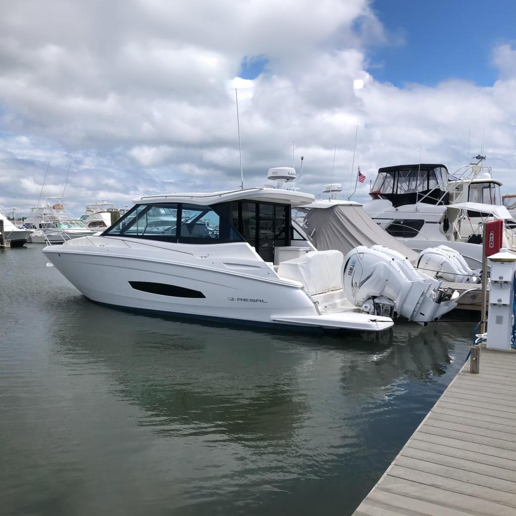 2022 Regal 36 XO boat docked at marina with other vessels.
