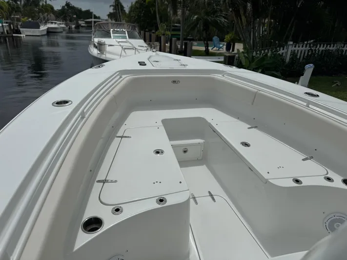  Yacht Photos Pics 2022 Sea Hunt 27 Gamefish boat interior, docked in a serene canal.