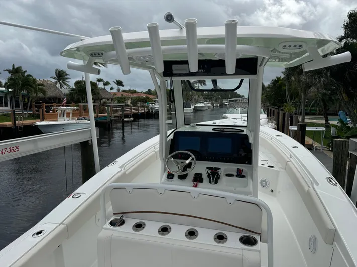  Yacht Photos Pics 2022 Sea Hunt 27 Gamefish boat docked in a marina, featuring a modern helm station.