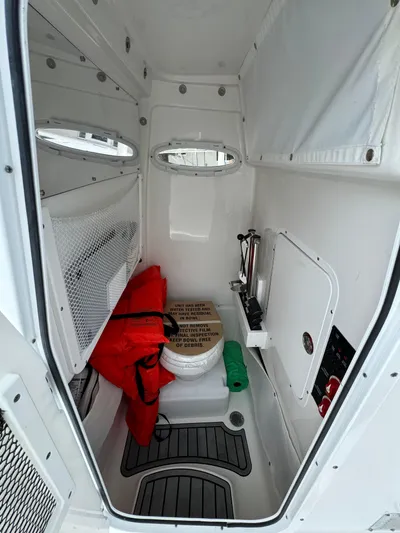 Yacht Photos Pics 2022 Sea Hunt 27 Gamefish boat interior with marine toilet and storage.