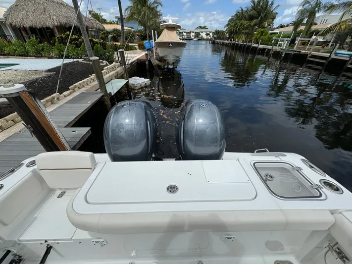  Yacht Photos Pics 2022 Sea Hunt 27 Gamefish boat docked in a canal with twin outboard engines.