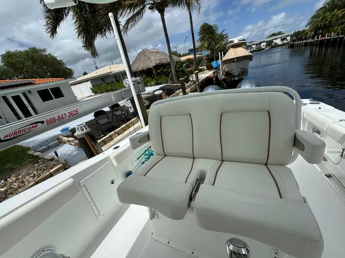  Yacht Photos Pics 2022 Sea Hunt 27 Gamefish boat with white cushioned seating, docked near waterfront homes.