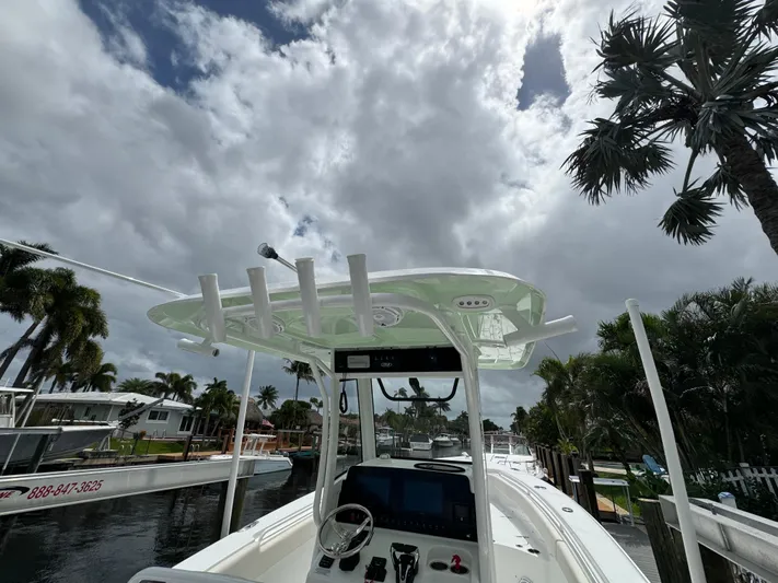  Yacht Photos Pics 2022 Sea Hunt 27 Gamefish boat docked under cloudy sky with palm trees.