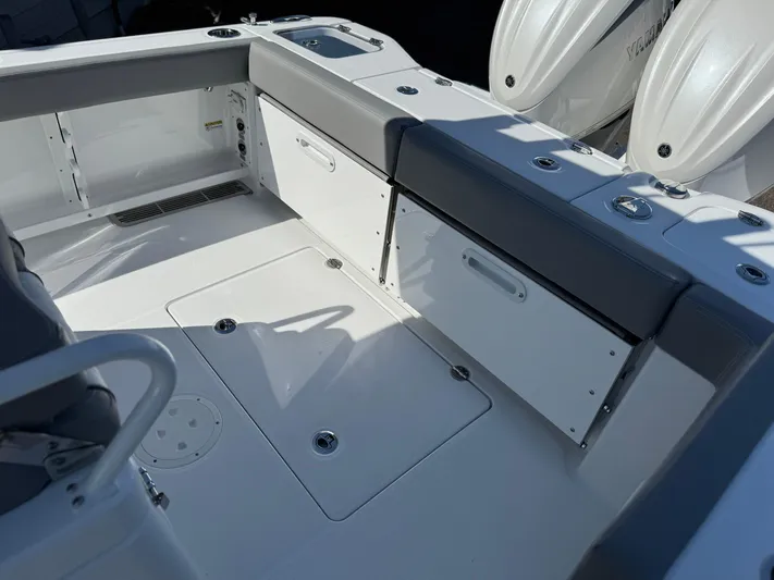  Yacht Photos Pics 2025 Everglades 285 Center Console boat interior with seating and storage compartments.