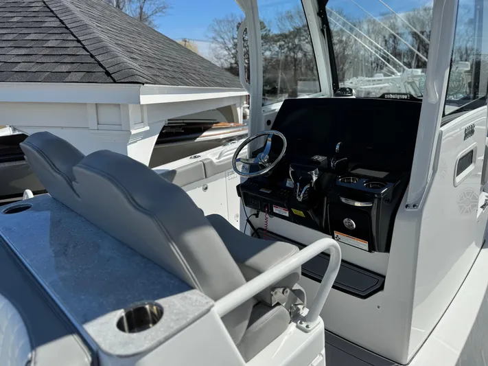  Yacht Photos Pics 2025 Everglades 285 Center Console boat interior with steering wheel and seating.