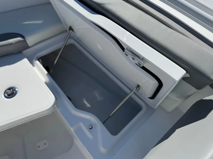  Yacht Photos Pics 2025 Everglades 285 Center Console boat storage compartment with open lid and hydraulic supports.