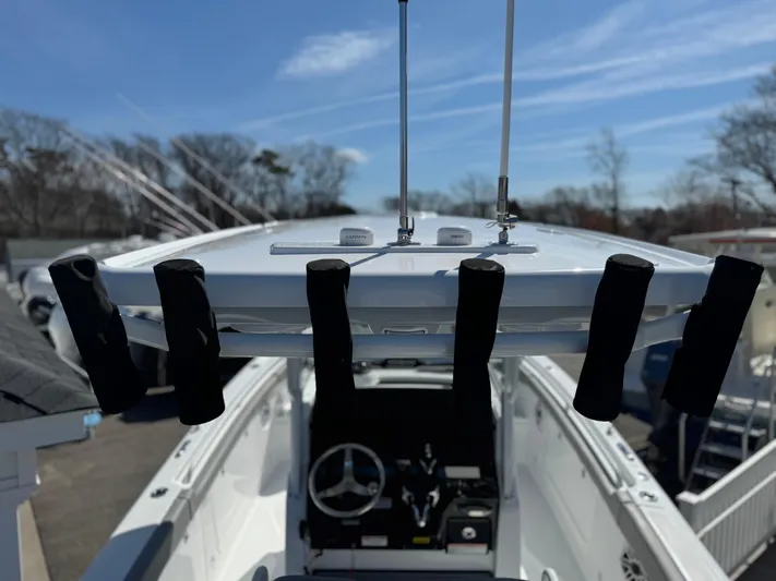  Yacht Photos Pics 2025 Everglades 285 Center Console boat with rod holders and antennas, under a clear blue sky.