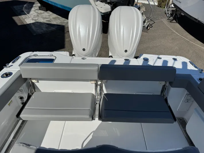  Yacht Photos Pics 2025 Everglades 285 Center Console boat with dual outboard engines and seating area.