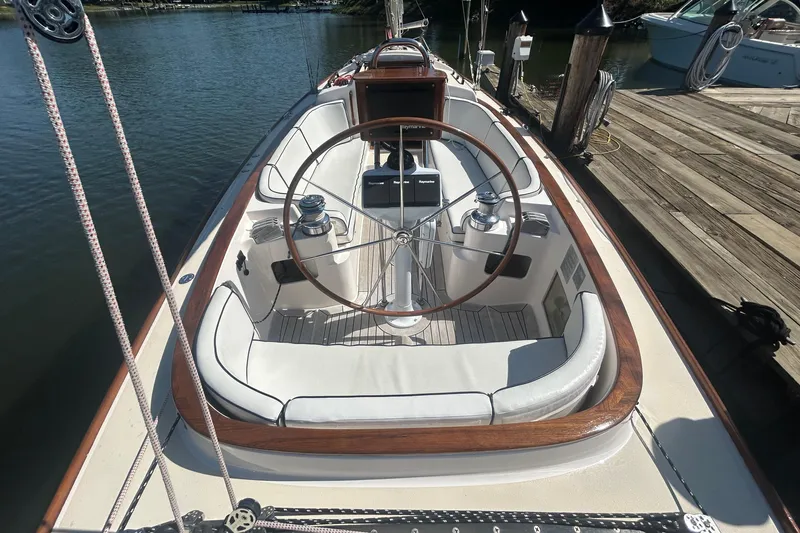  Yacht Photos Pics 2008 Alerion Express 33 sailboat cockpit with wooden accents and steering wheel at dock.