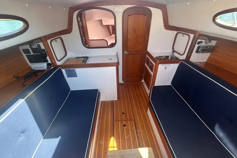  Yacht Photos Pics Interior of 2008 Alerion Express 33 sailboat with wooden flooring and blue seating.