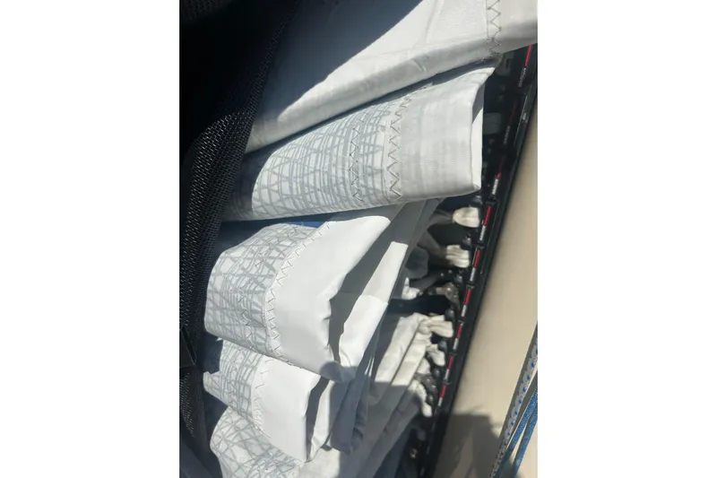  Yacht Photos Pics Rolled sails on a 2008 Alerion Express 33 sailboat, showcasing detailed stitching.