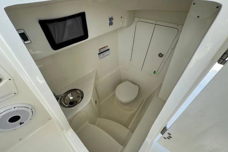 Pcm 55856 296dc Yacht Photos Pics 2025 World Cat 296 DC boat interior with compact bathroom and sink.
