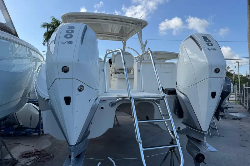 Pcm 55856 296dc Yacht Photos Pics 2025 World Cat 296 DC boat with dual 300 V8 engines, docked under a clear sky.