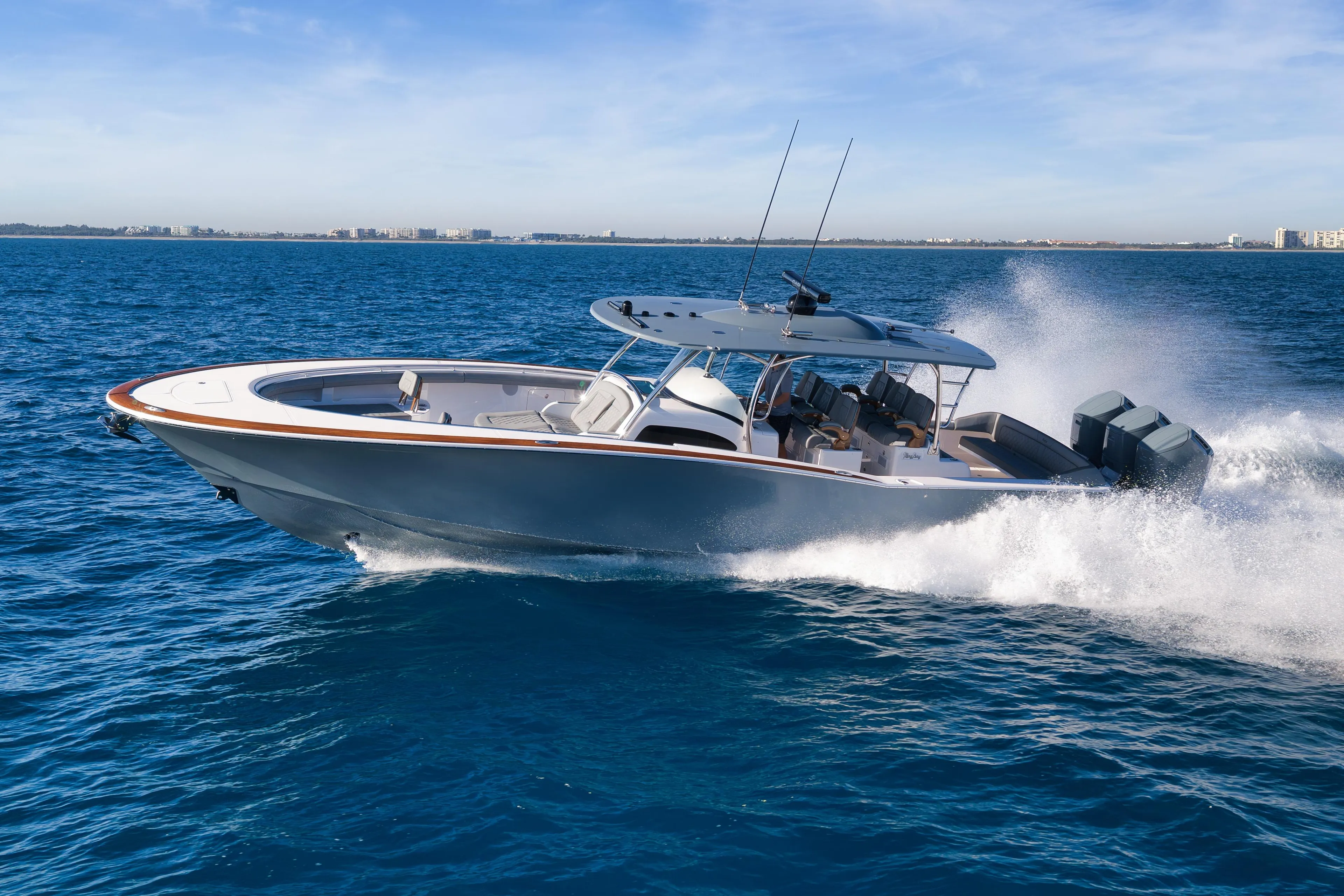 2026 Mag Bay 43 CC cruising on open water, showcasing sleek design and powerful engines.