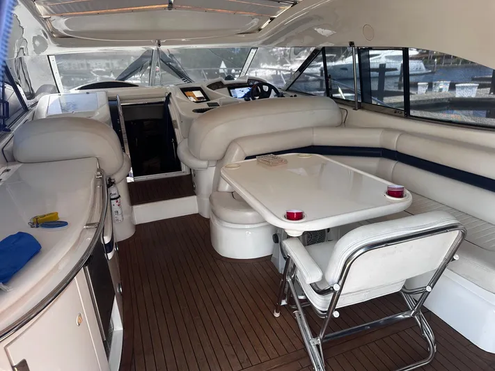 Hot Stuff Yacht Photos Pics Luxurious interior of a 2000 Sunseeker Predator 56 yacht with elegant seating and dining area.