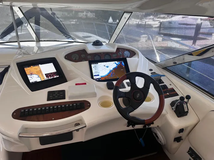 Hot Stuff Yacht Photos Pics Helm of 2000 Sunseeker Predator 56 yacht with navigation screens and controls.