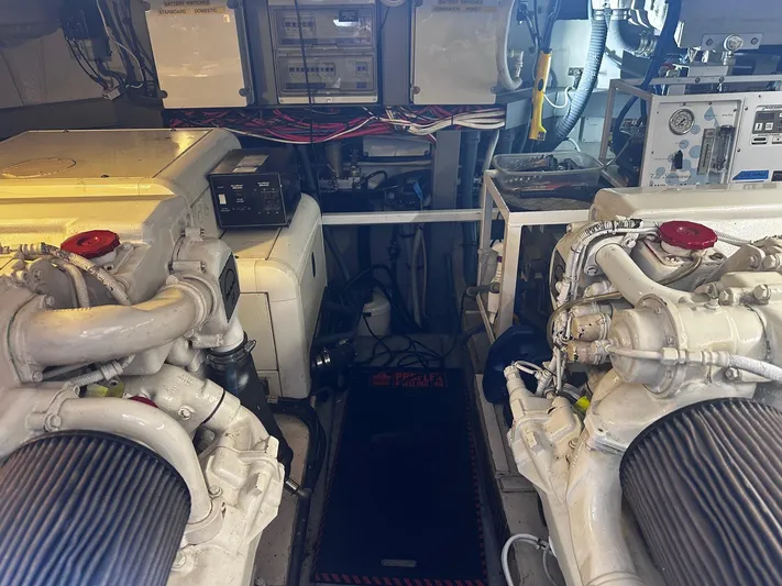 Hot Stuff Yacht Photos Pics Engine room of a 2000 Sunseeker Predator 56 yacht, showcasing dual engines and control systems.