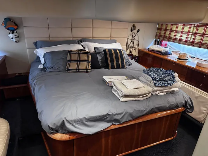 Hot Stuff Yacht Photos Pics Luxurious bedroom interior of a 2000 Sunseeker Predator 56 yacht with neatly arranged bedding.