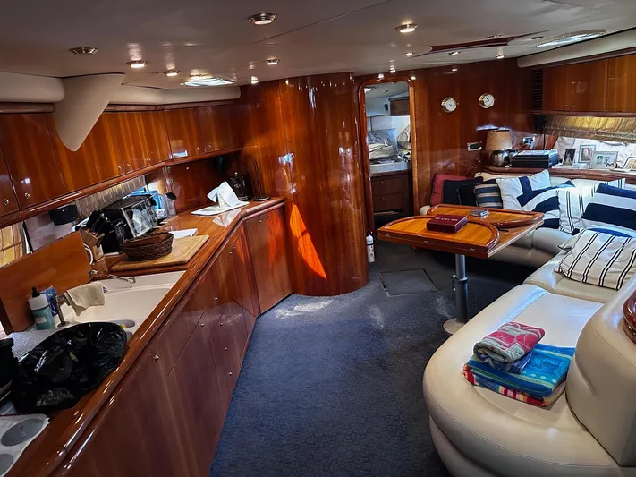 Hot Stuff Yacht Photos Pics Luxurious interior of a 2000 Sunseeker Predator 56 yacht with wood finishes and cozy seating.