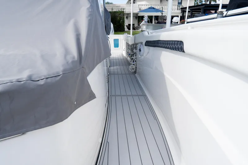  Yacht Photos Pics 2023 Tidewater 380 CC Adventure boat deck with sleek design and covered seating area.