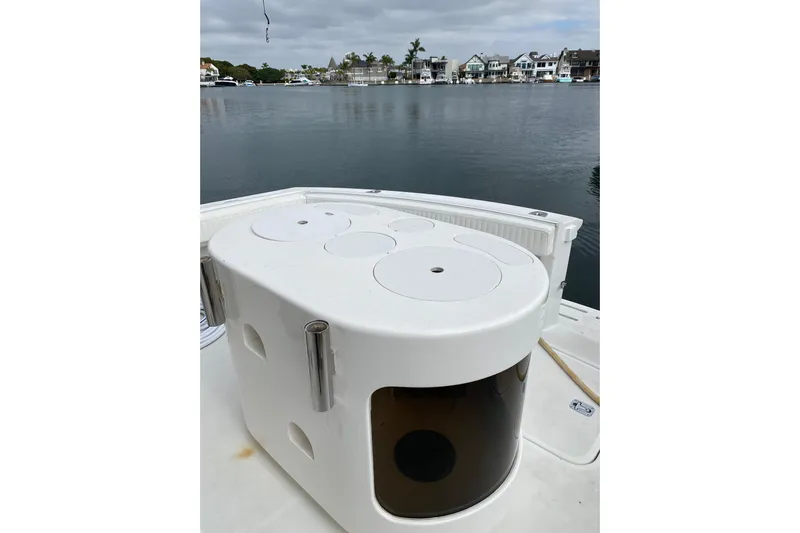  Yacht Photos Pics 1995 Hatteras 50 Convertible Sportfish boat deck with fishing equipment, docked by waterfront homes.