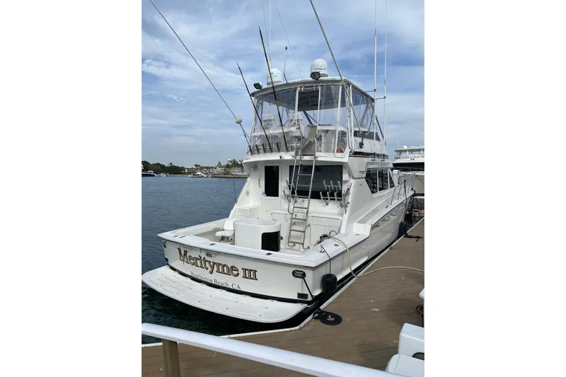  Yacht Photos Pics 1995 Hatteras 50 Convertible Sportfish boat docked, rear view with clear skies.