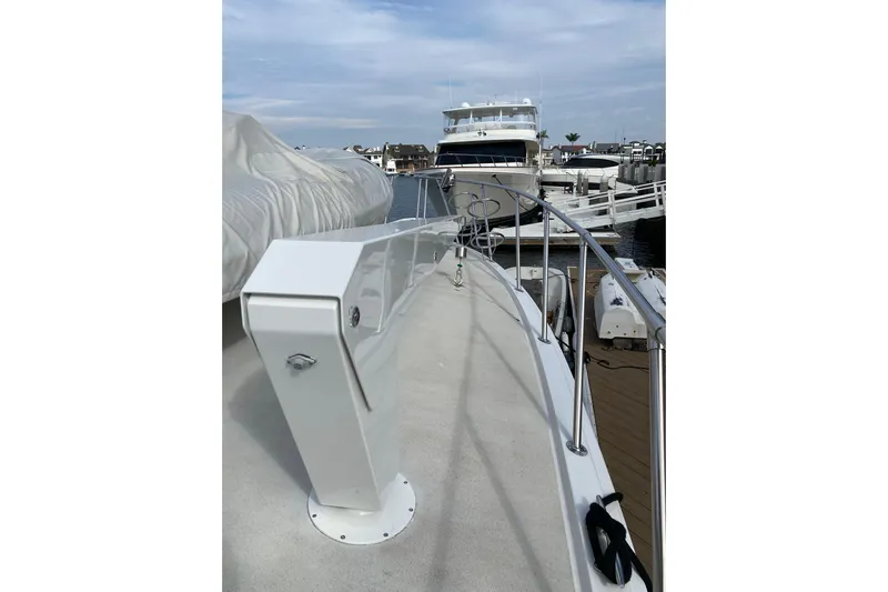  Yacht Photos Pics 1995 Hatteras 50 Convertible Sportfish yacht docked at marina, showcasing sleek deck design.