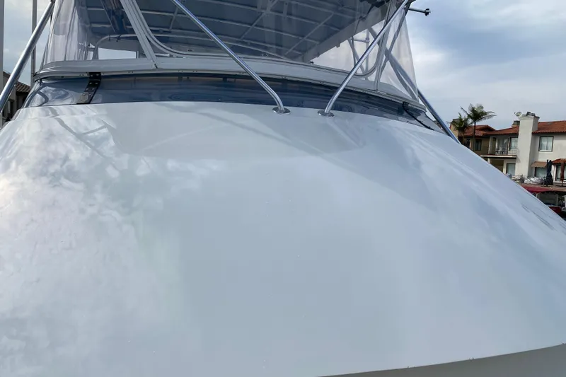  Yacht Photos Pics 1995 Hatteras 50 Convertible Sportfish boat with sleek white exterior and clear canopy.